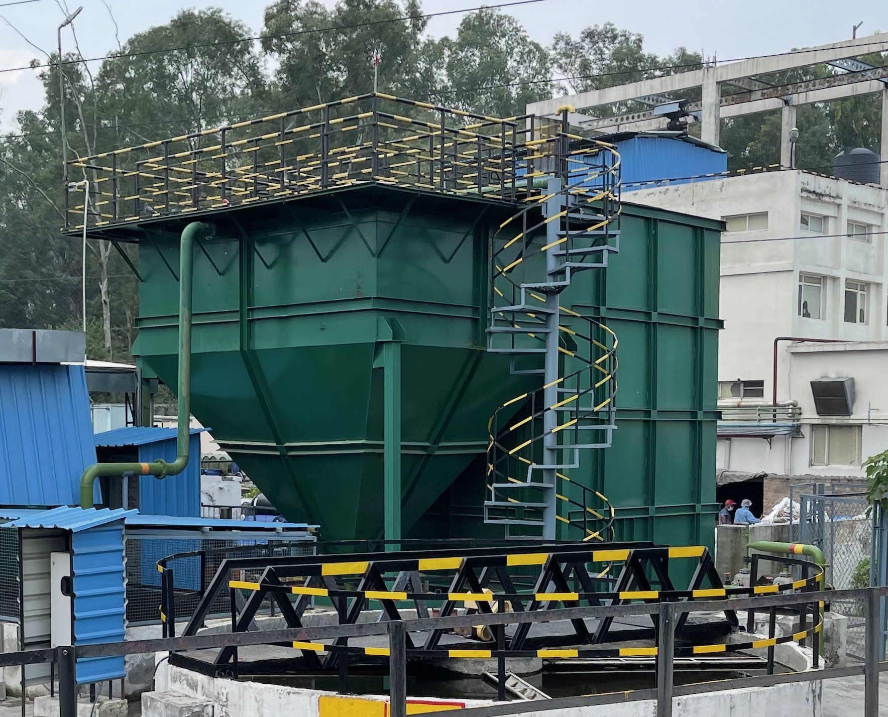 Green hopper-bottom ETP tank with spiral staircase